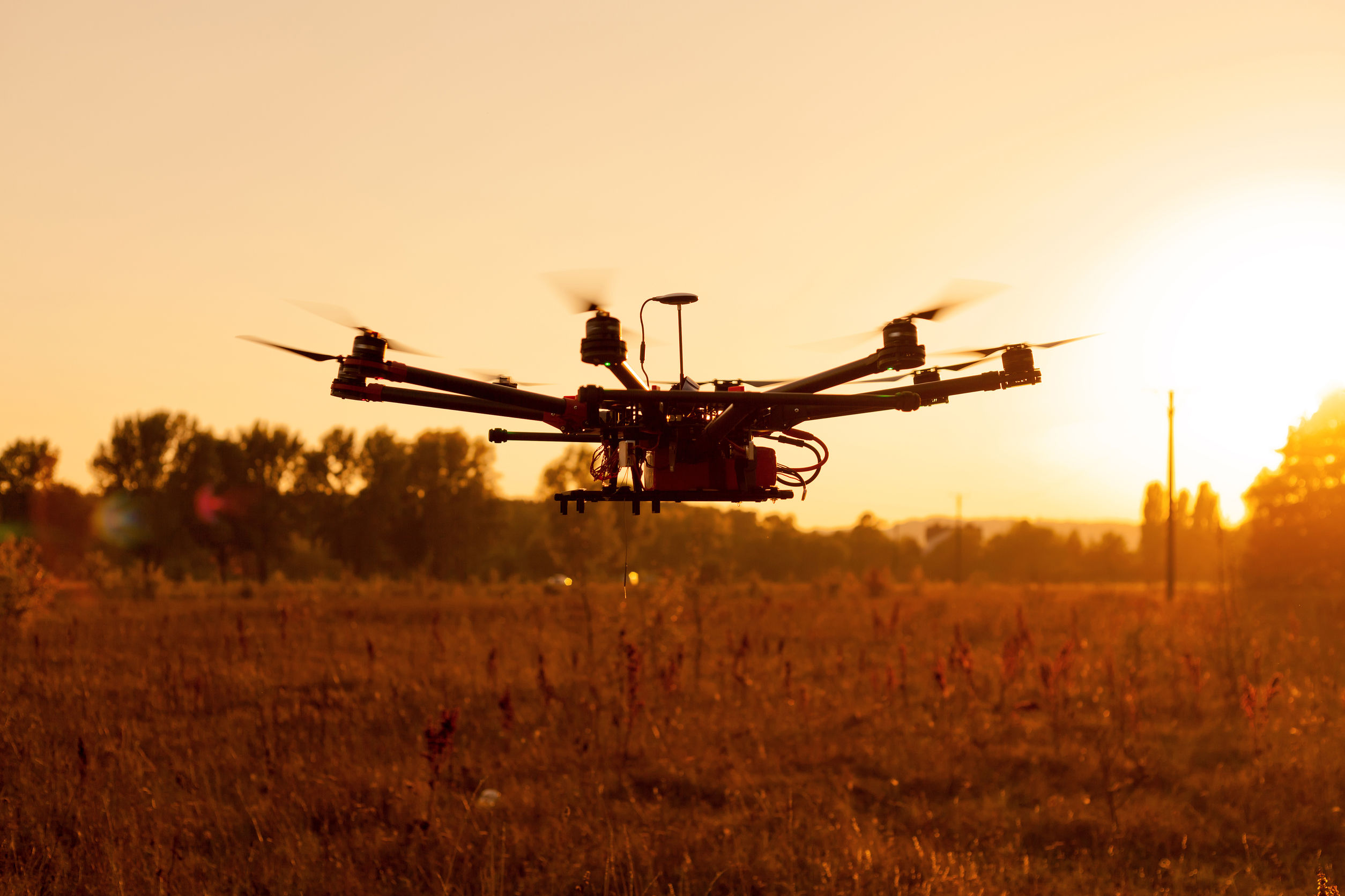 drone on a background of a beautiful sunset. uav in flight. quadrocopters on radio.